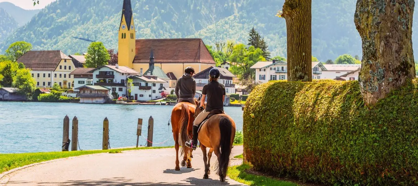 Horseback riding along the shore of Lake Tegernsee on a sunny summer day