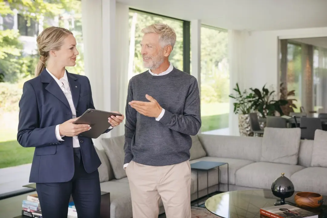Estate agent in conversation with elderly owner